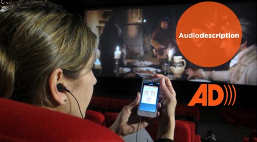 Diapo 5 : Femme au cinéma qui utilise la fonctionnalité 'audio-description' sur son smartphone avec l'application Twavox